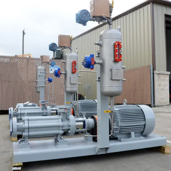 Industrial pumps and motors arranged outdoors.