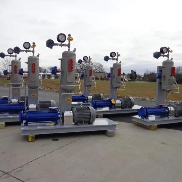 Industrial pumps arranged on a concrete surface.